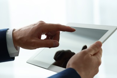 Closeup view of man using new tablet indoors