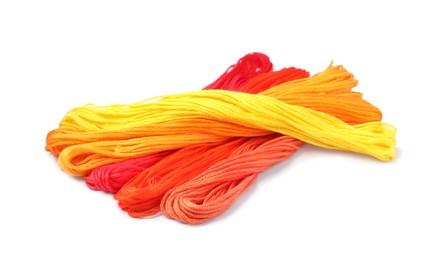 Different colorful embroidery threads on white background