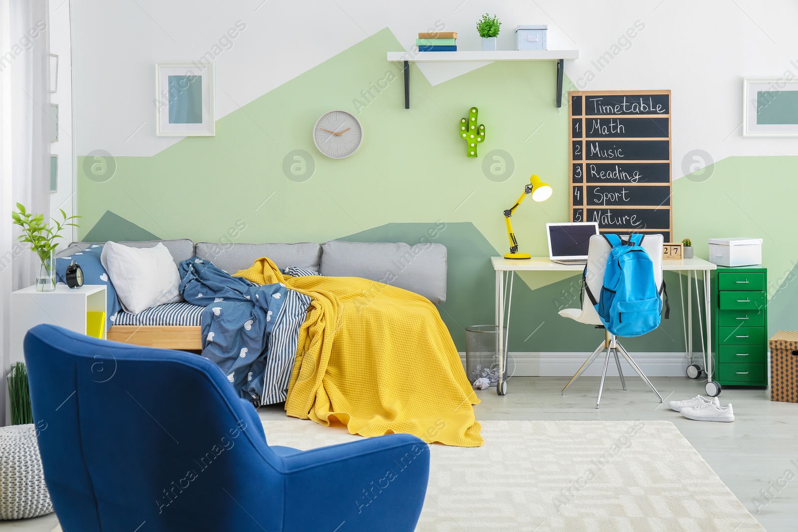 Photo of Modern child room interior with comfortable armchair and bed