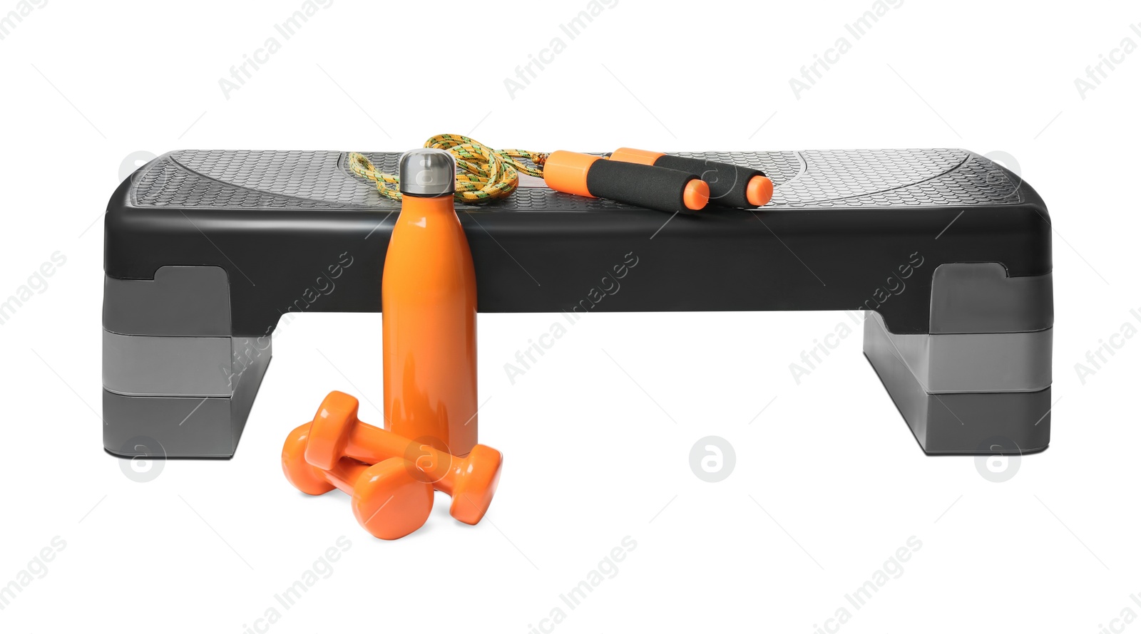 Photo of Step platform, jump rope, dumbbells and bottle on white background. Sports equipment