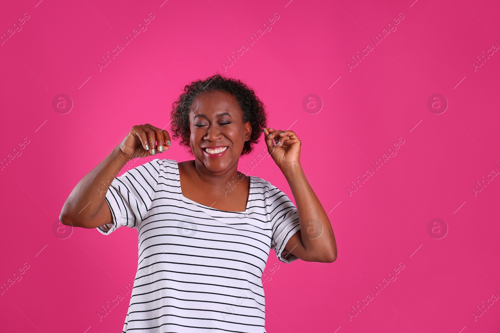 Photo of Portrait of dancing African-American woman on pink background