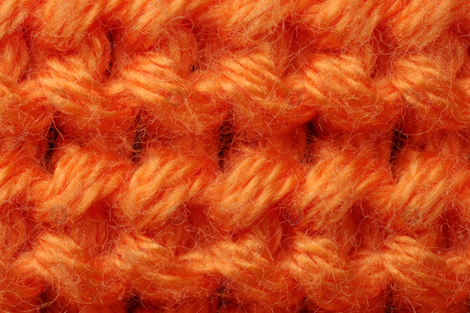 Photo of Macro photo of orange knitted fabric as background, top view