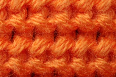 Photo of Macro photo of orange knitted fabric as background, top view
