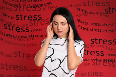 Young woman suffering from depression and words STRESS on red background
