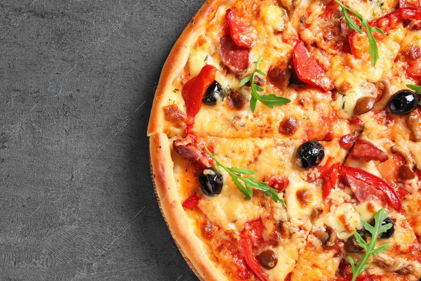 Photo of Delicious pizza with olives and sausages on table, top view