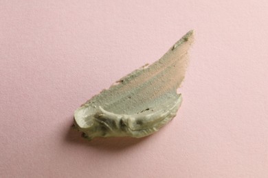 Photo of Sample of face cream on pink background, top view