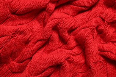 Photo of Texture of soft red knitted fabric as background, top view