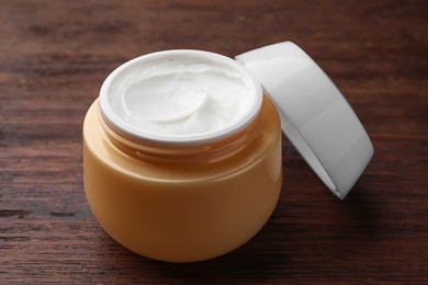 Photo of Jar of face cream on wooden table