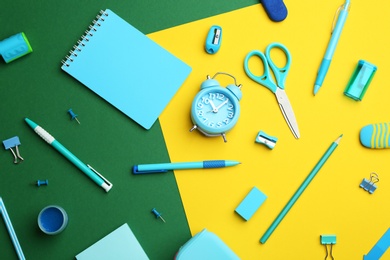 Photo of Different bright school stationery on color background, flat lay