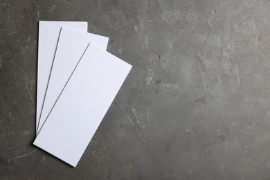Photo of Blank business cards on grey textured background, top view. Mockup for design