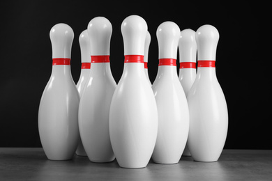 Photo of Set of bowling pins on grey stone table