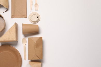 Photo of Eco friendly food packaging. Paper containers, bag and tableware on white background, flat lay. Space for text