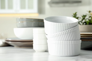 Set of beautiful tableware on white table in kitchen