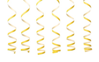Photo of Yellow serpentine streamers on white background. Festive decor