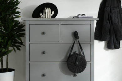 Photo of Grey chest of drawers in stylish room. Interior design