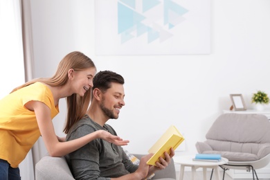 Photo of Father and his teenager daughter with book at home