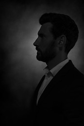 Image of Silhouette of man in darkness. Portrait on black background