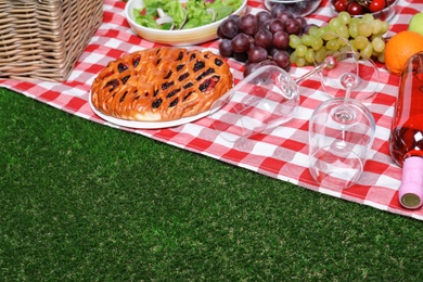 Photo of Many different products on checkered picnic blanket, space for text