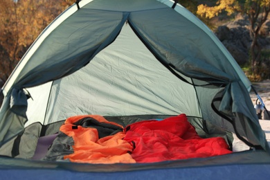 Photo of Camping tent with sleeping bags in wilderness