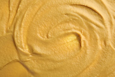 Photo of Fresh tasty mustard sauce as background, top view