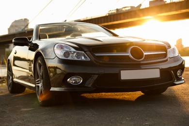 Photo of Luxury black convertible car outdoors at sunset