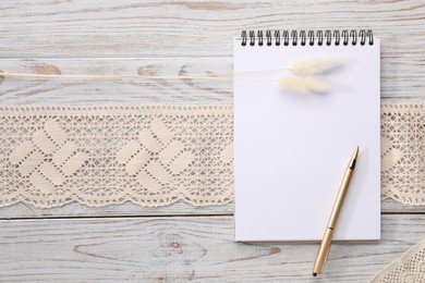Photo of Guest list. Notebook, pen, spikelets and lace ribbon on wooden background, flat lay. Space for text