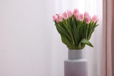 Photo of Beautiful bouquet of fresh pink tulips indoors. Space for text
