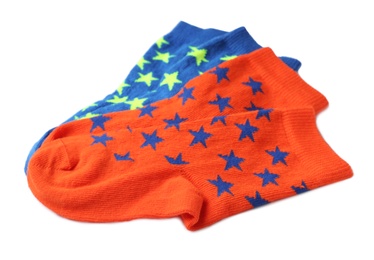Photo of Cute child socks with stars on white background