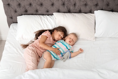 Photo of Little children sleeping in bed at home