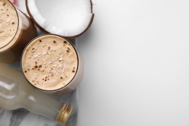 Photo of Delicious coffee with coconut syrup on white table, flat lay. Space for text