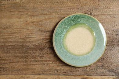 Photo of Stylish cup coaster on wooden table , top view. Space for text