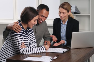 Photo of Couple consulting with professional notary in office
