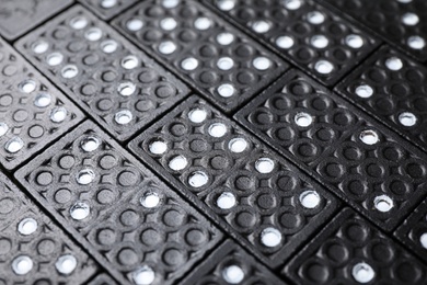 Photo of Set of black domino tiles as background, closeup