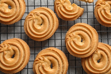 Photo of Baking grid with Danish butter cookies on table, top view