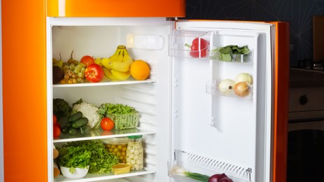 Photo of Modern open refrigerator full of many different products