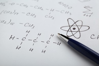 Photo of Sheet of paper with different chemical formulas and pen, closeup