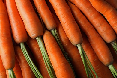 Photo of Many tasty fresh carrots as background, closeup