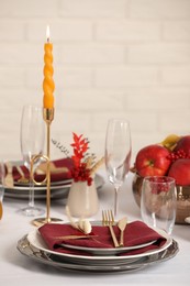 Photo of Elegant festive setting with autumn decor on table