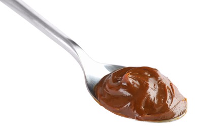 Photo of Spoon with tasty boiled condensed milk isolated on white