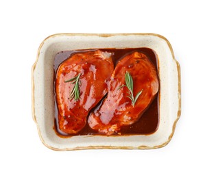 Photo of Raw marinated meat and rosemary in baking dish isolated on white, top view