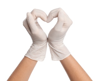 Doctor in medical gloves showing heart with hands on white background, closeup