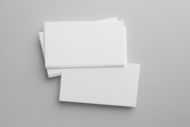 Photo of Blank business cards on light gray background, top view. Mockup for design