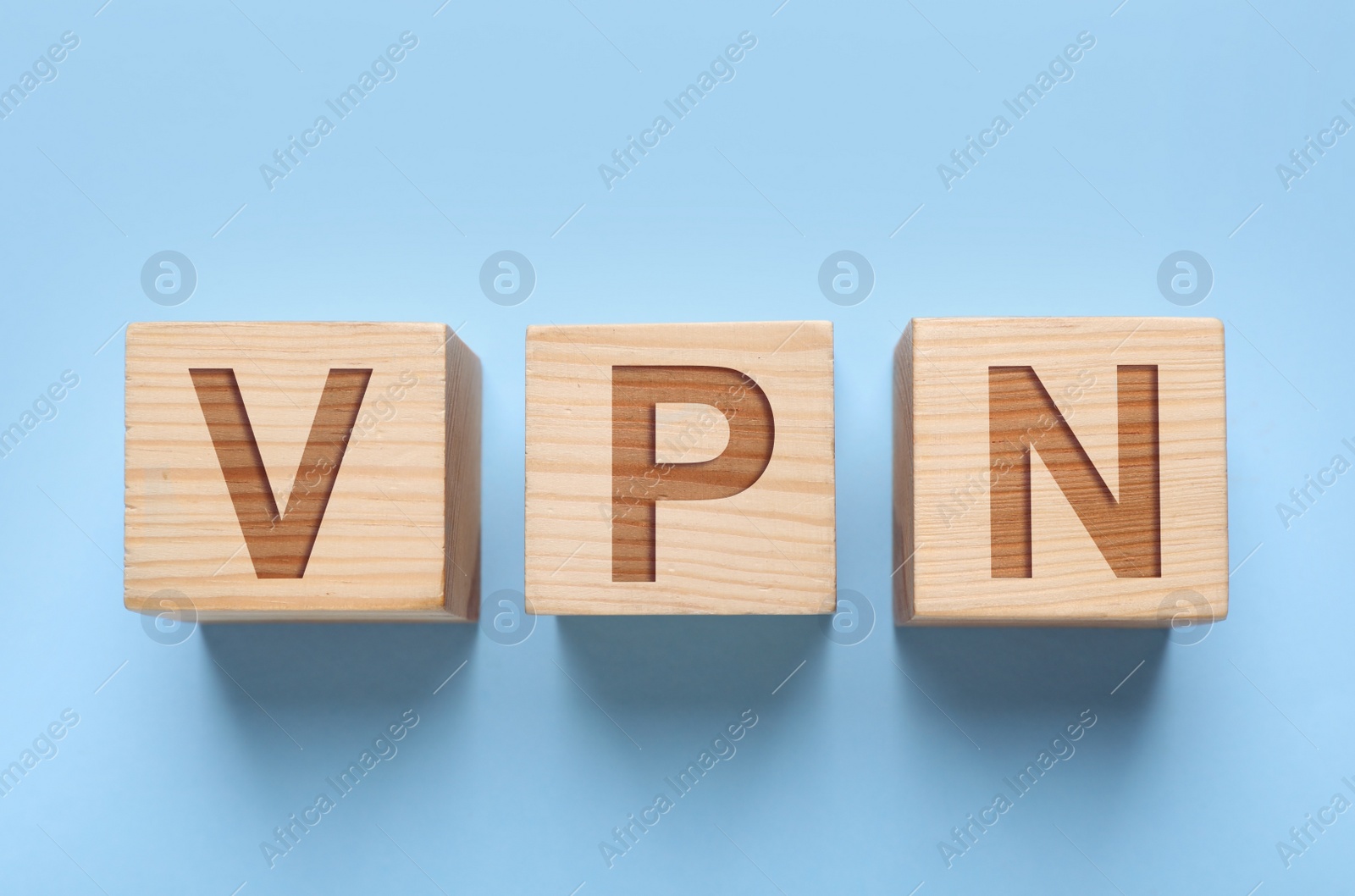 Image of Wooden cubes with acronym VPN on light blue background, flat lay