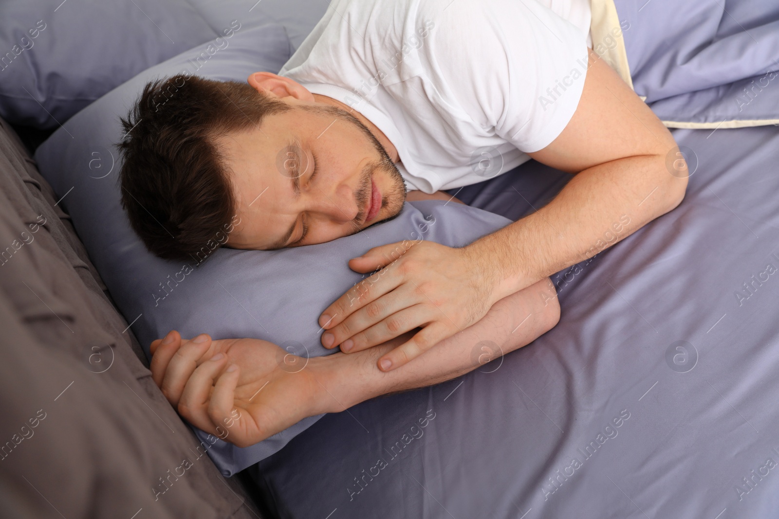 Photo of Handsome man sleeping on pillow at home. Bedtime