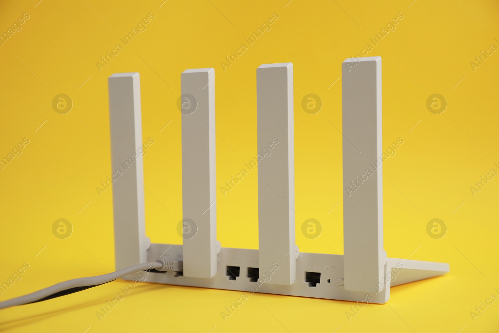 Photo of One modern Wi-Fi router on yellow background