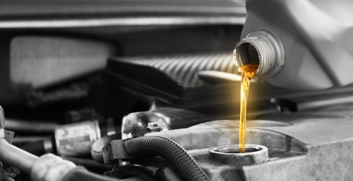 Pouring motor oil into car engine, color accent effect. Banner design