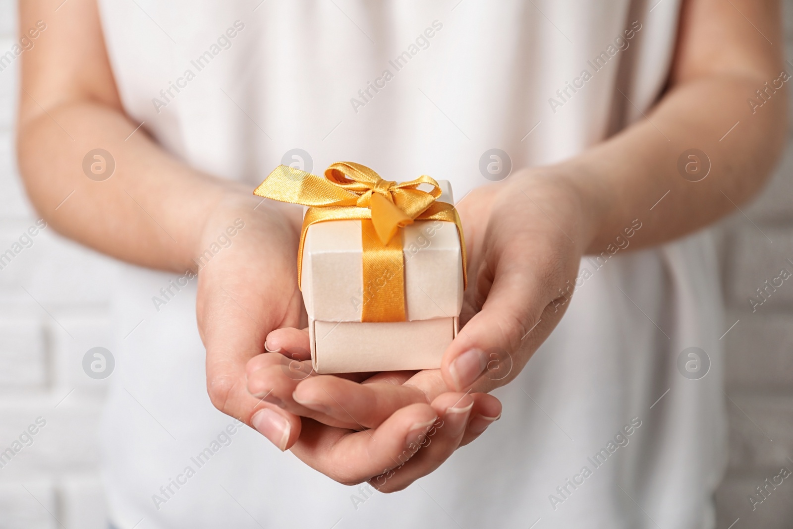 Photo of Woman holding beautiful gift box, closeup