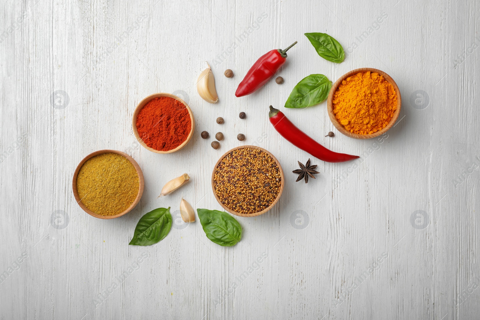 Photo of Flat lay composition with different aromatic spices on wooden background