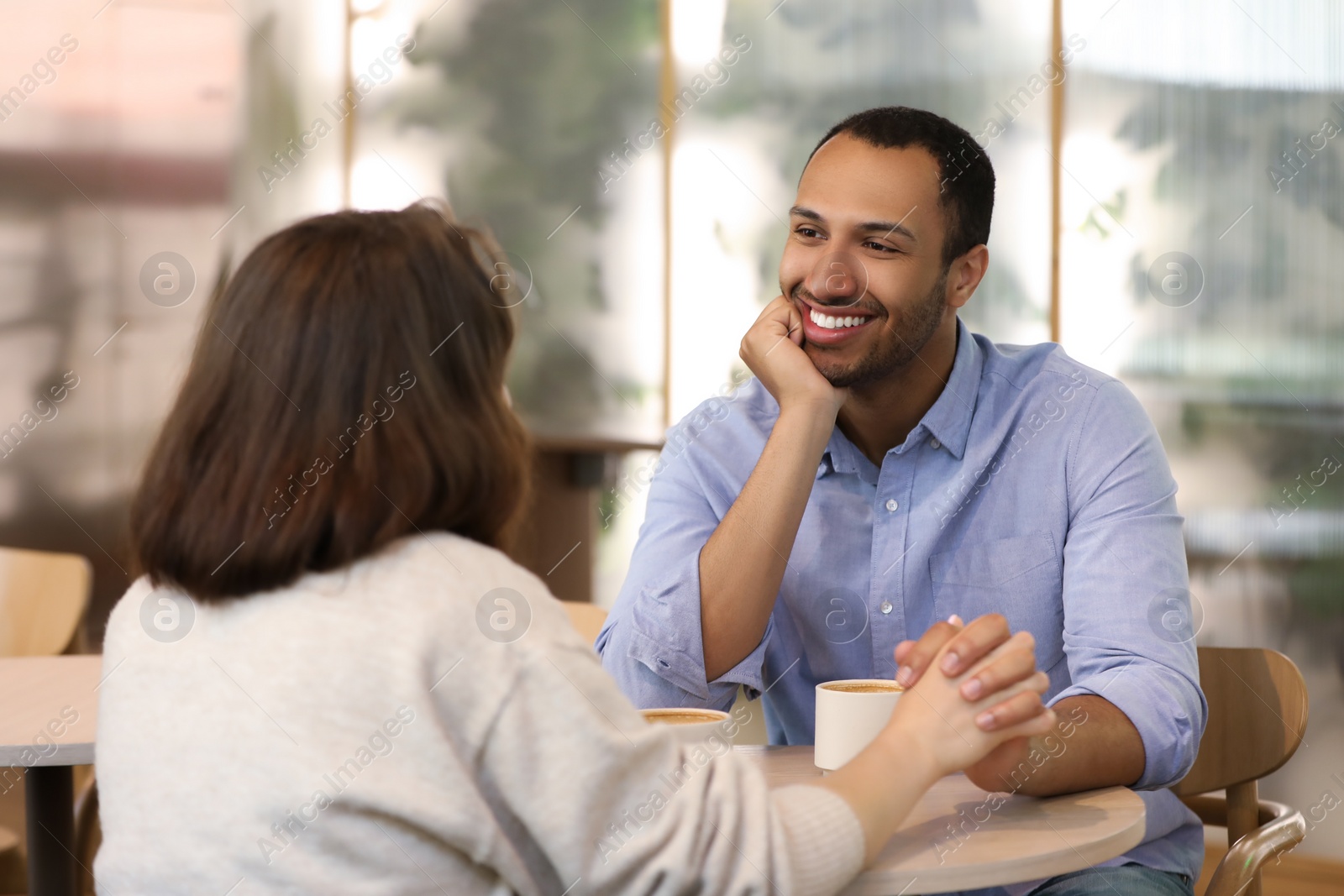 Photo of Romantic date. Happy couple spending time together in cafe