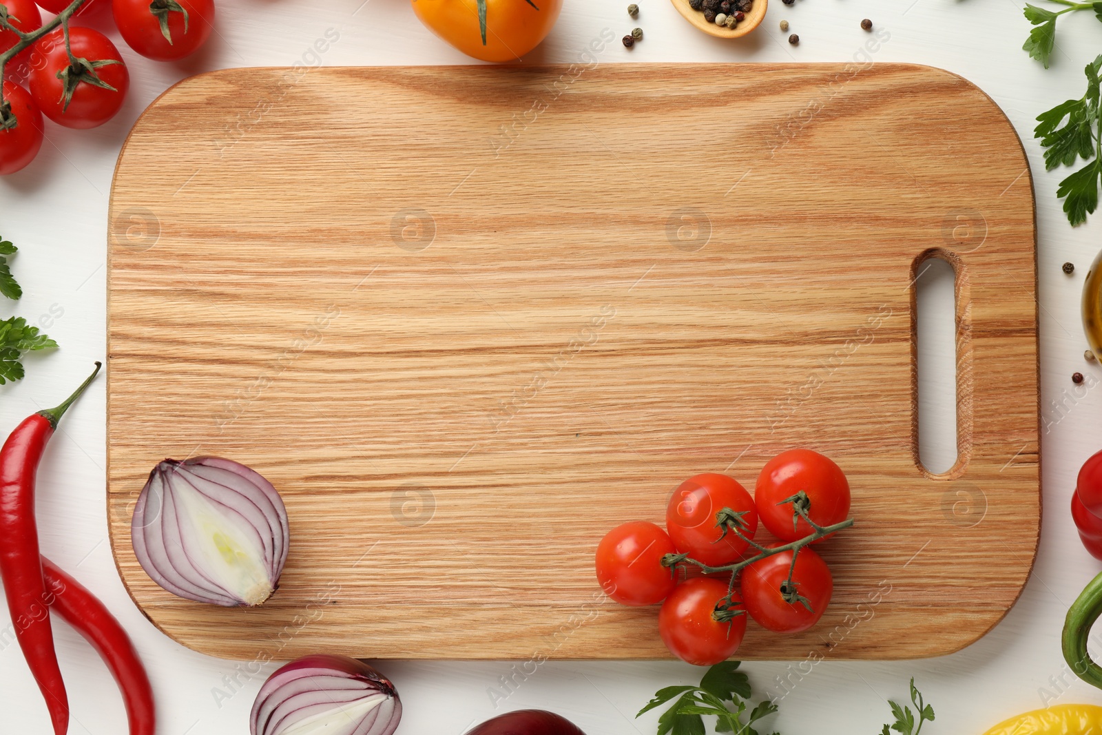Photo of Cutting board with vegetables on white wooden table, flat lay. Space for text